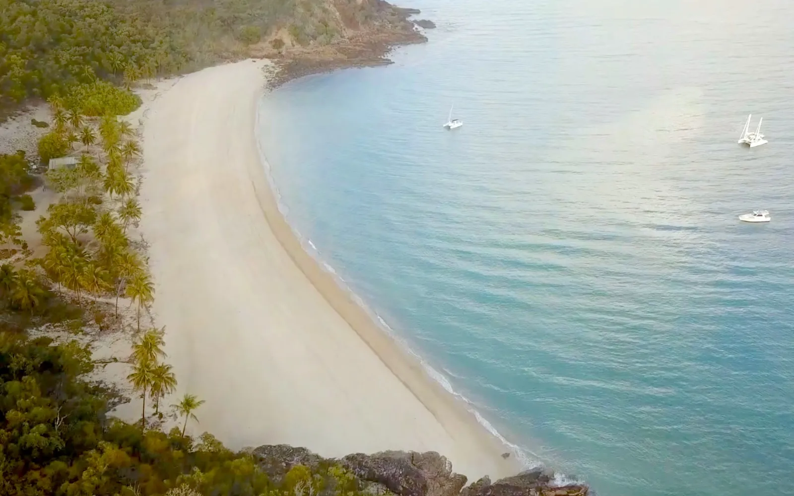 Aerial view of a white sand beach and turquoise bay on Middle Percy Island